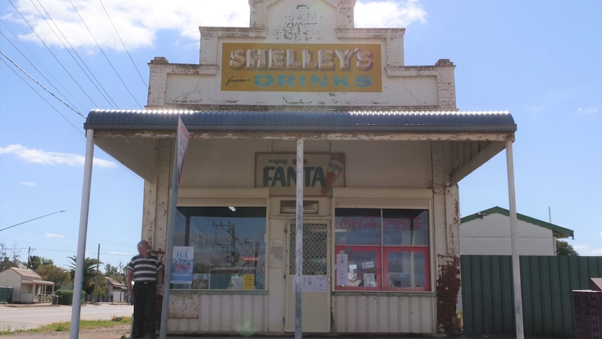 A man outside an old shop