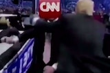 A screenshot from a mock video Donald Trump tweet showing him body slamming CNN in a wrestling match.