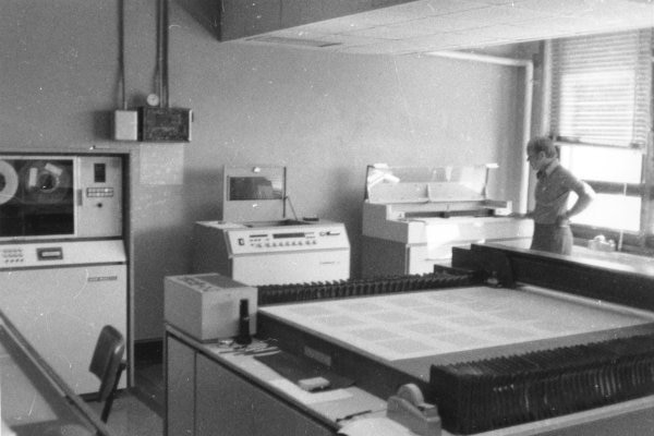 A worker using a flatbed plotter.