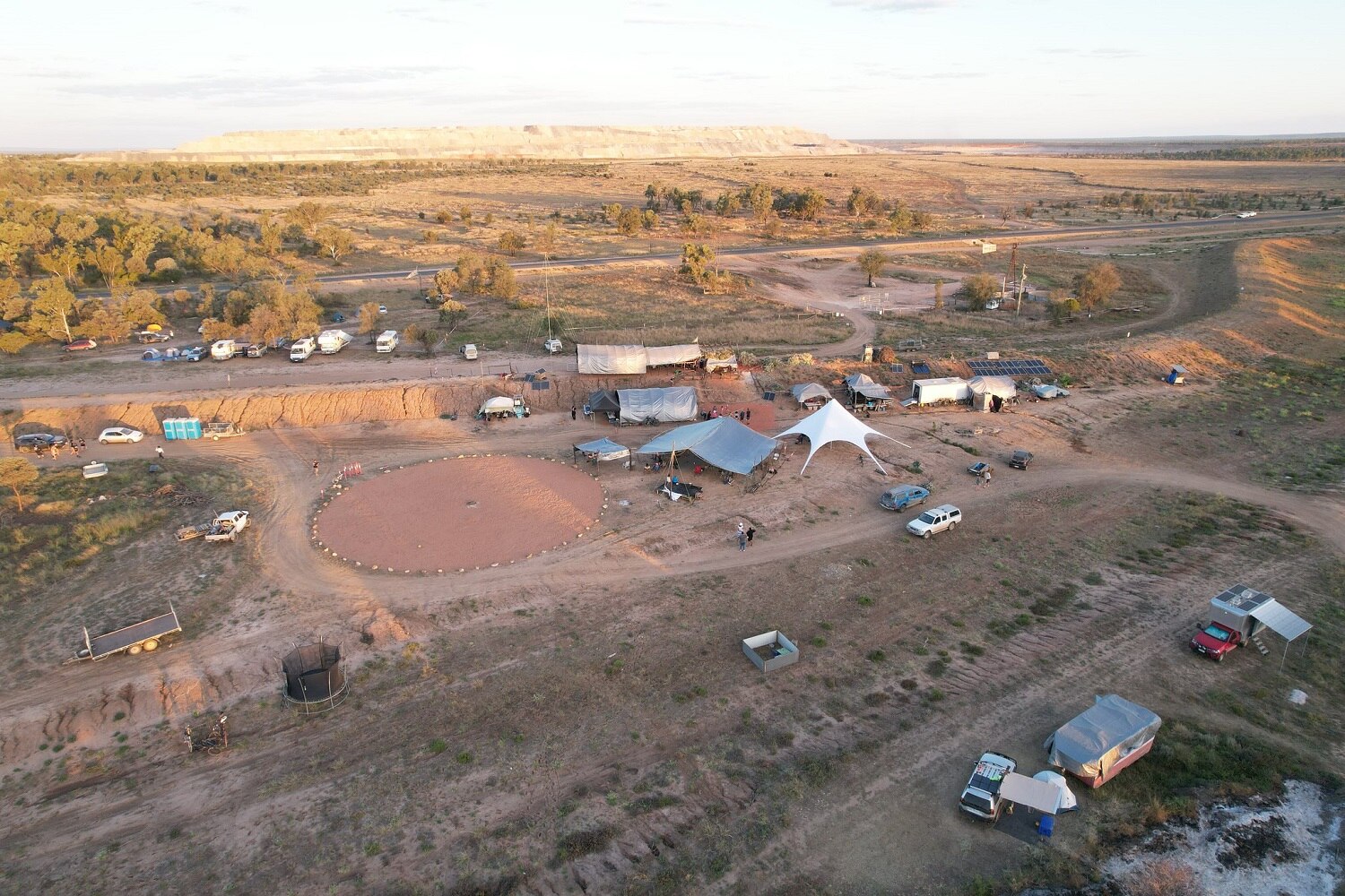 drone shot of a bora ring and camp site near a coal mine