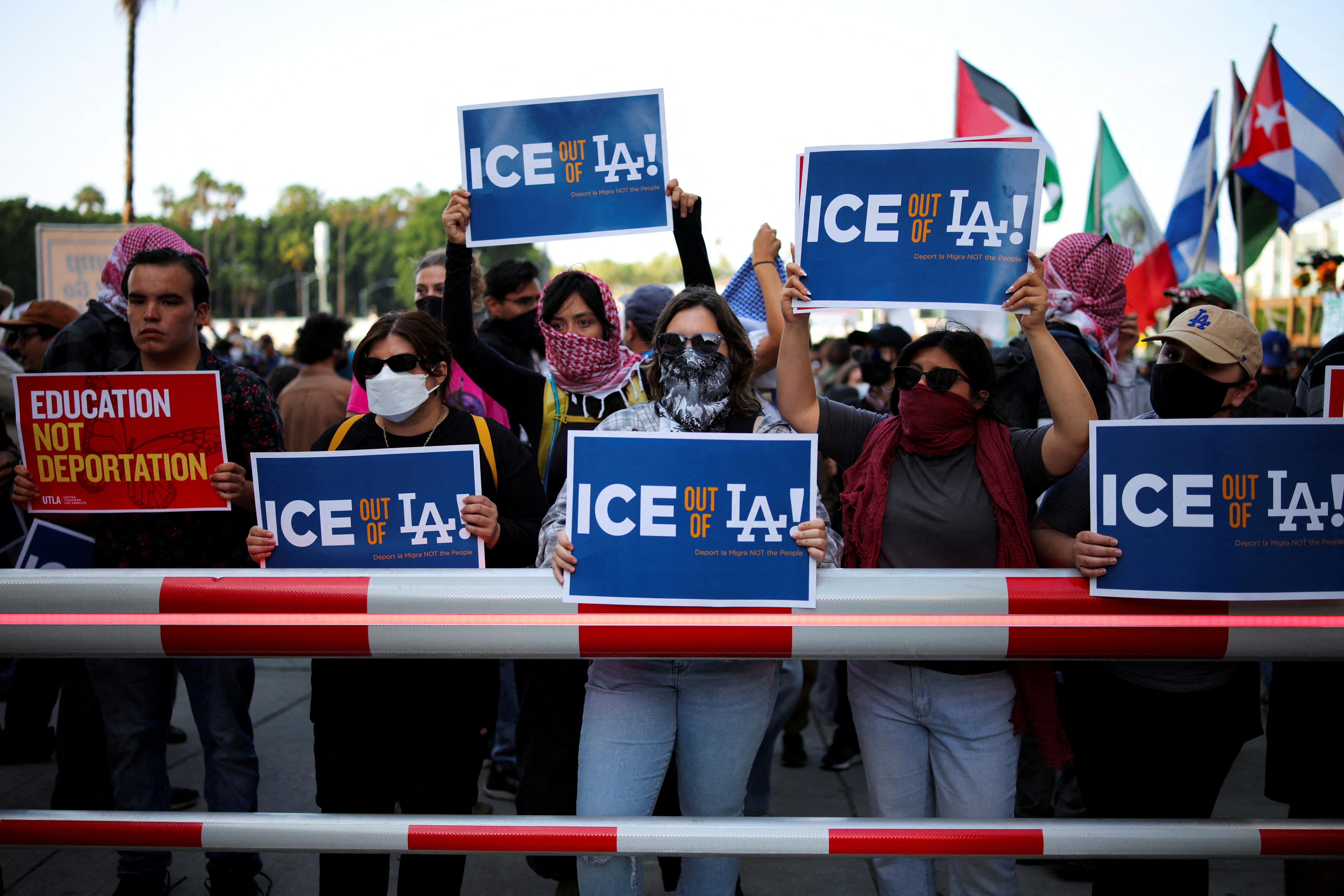 A crowd of protesters hold signs that read: "ICE our of LA!" 