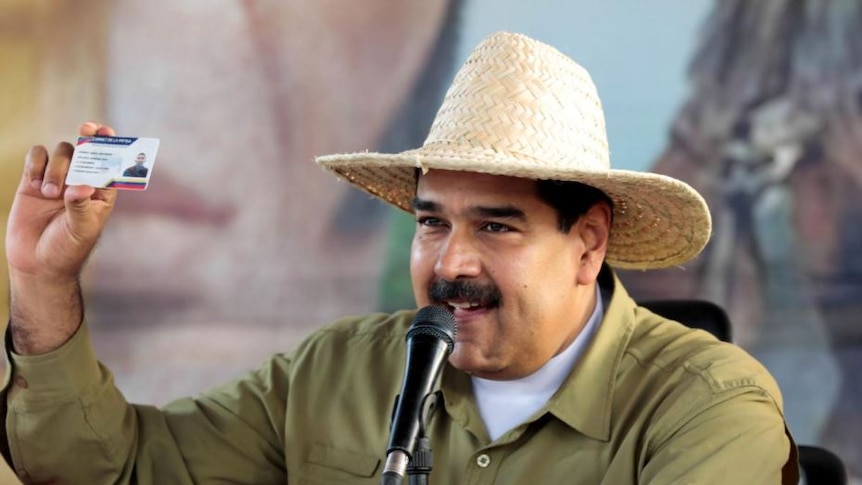 Nicolas Maduro shows off Venezuelan fatherland card wearing a straw brim hat