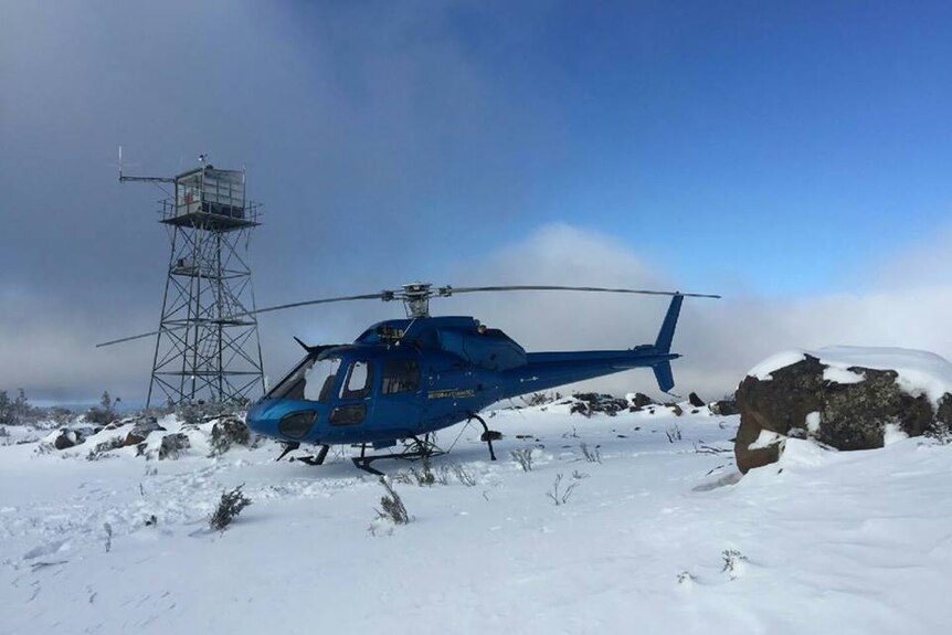 A RotorLift helicopter landed in a snow field.
