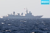 A large ship flying China's flag sits on open waters.