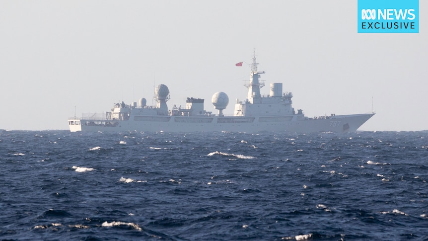 A large ship flying China's flag sits on open waters.