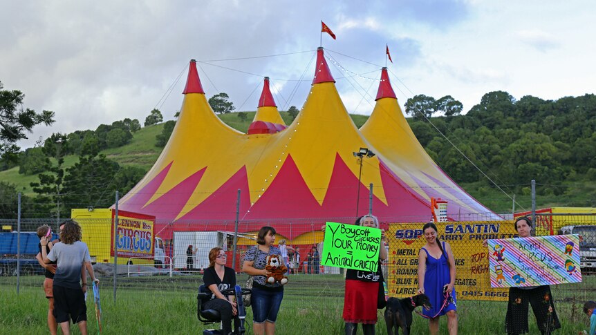 Protesters in front of circus big top
