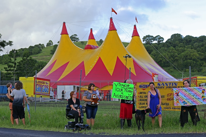 Protesters in front of circus big top