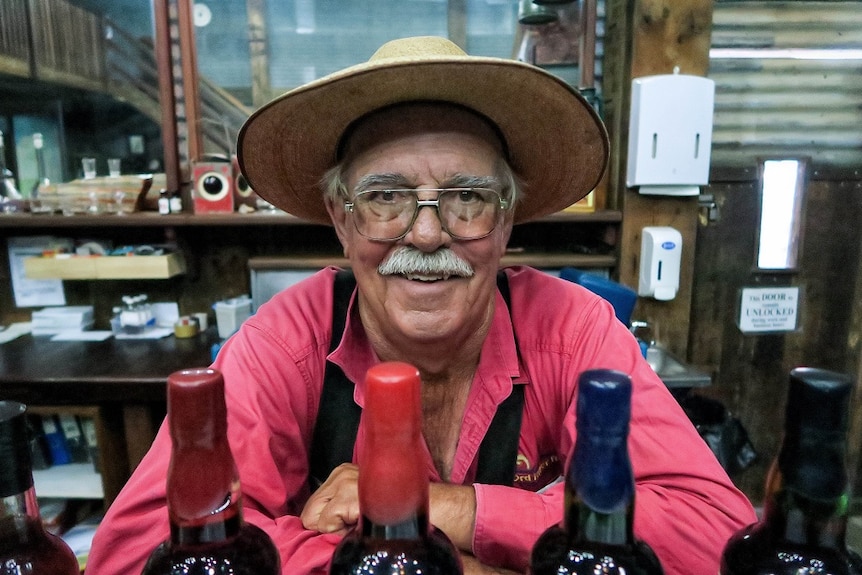 Spike Dessert behind bottles of rum in the Hoochery.