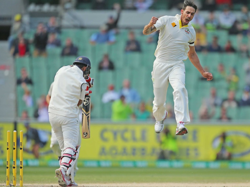 Australia's Mitchell Johnson celebrates after bowling Cheteshwar Pujara at the MCG.