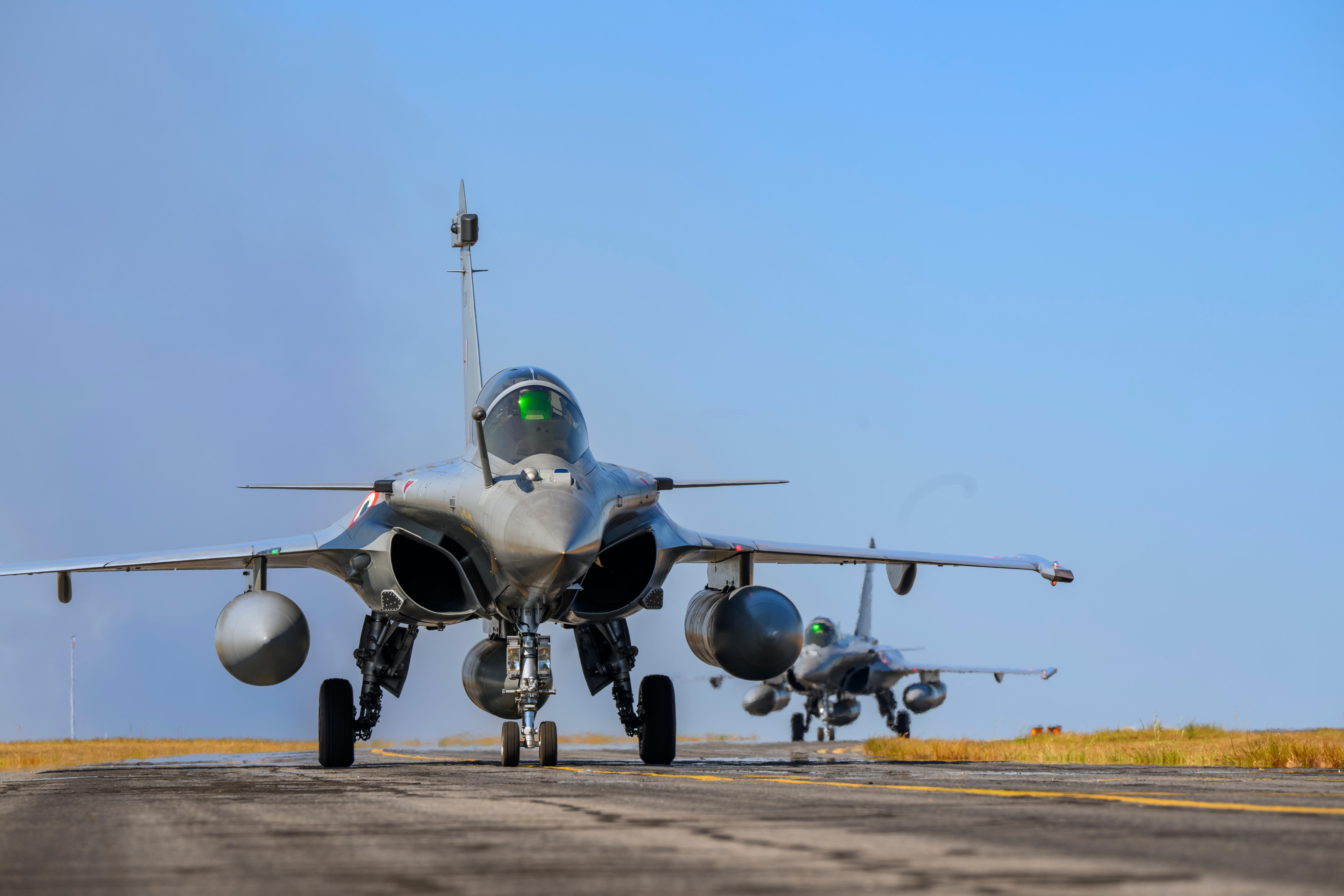 Two fighter jets on a runway.