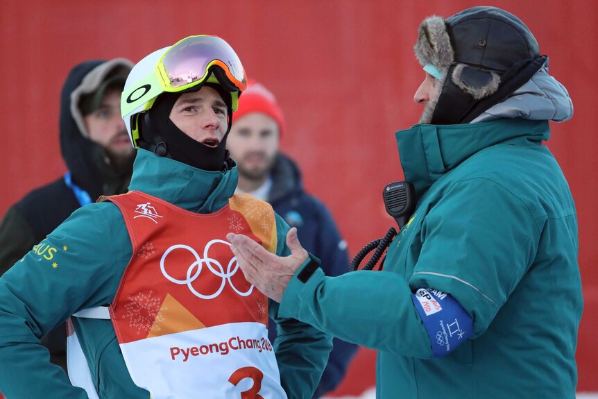 Australian moguls skier Matt Graham (L), talks with a coach ahead of Pyeongchang Winter Olympics.