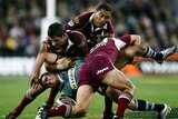 Danny Buderus is gang tackled by the Maroons defence