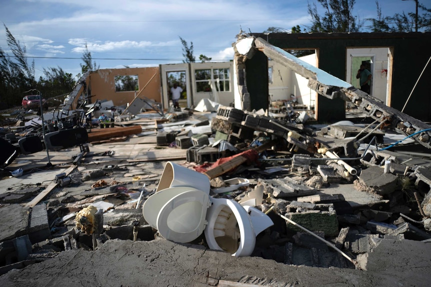 A toilet sits in the debris of a home destroyed by Hurricane Dorian in Freeport, Bahamas.