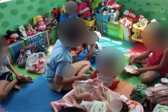 Children sit in a playroom