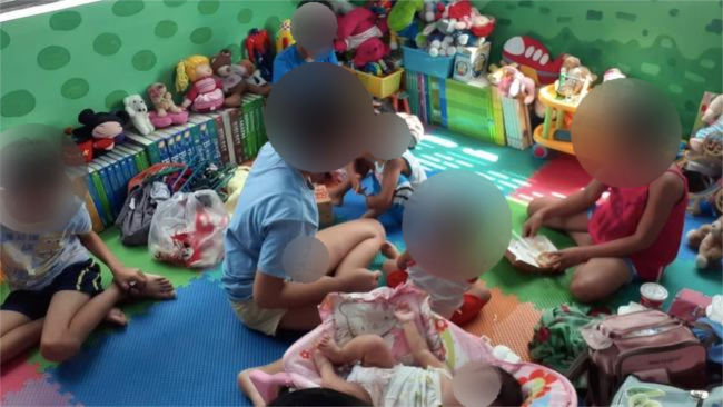 Children sit in a playroom