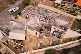 An aerial view of a house that has been destroyed by a ferocious storm.
