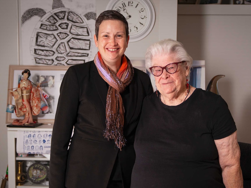 Patricia and Dr Lane smile into the camera, some artwork behind them.