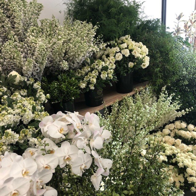 White flowers inside a florist.
