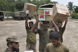 Flood aid arrives slowly: Pakistani soldiers unload boxes of medicines from China