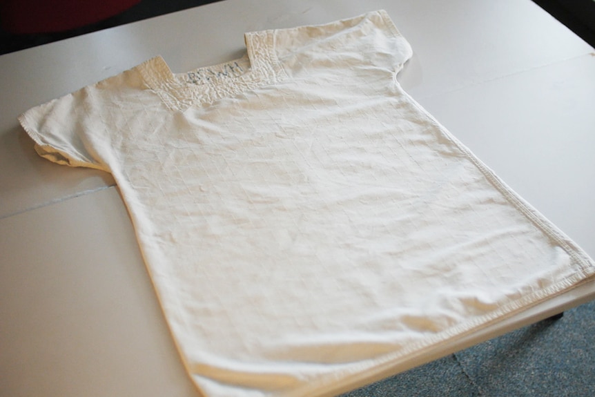 A basic, white smock, with thick quilted fabric.