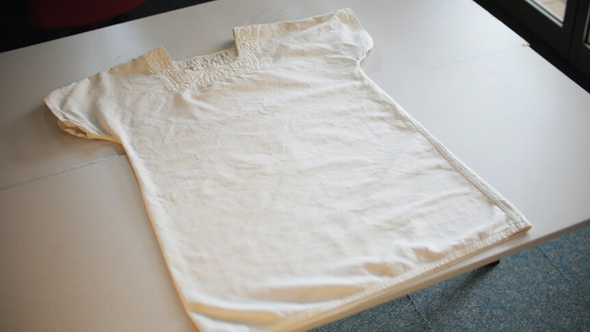 A basic, white smock, with thick quilted fabric.