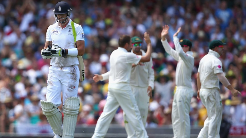 Kevin Pietersen walks back to the pavilion after being dismissed by Australia's Ryan Harris