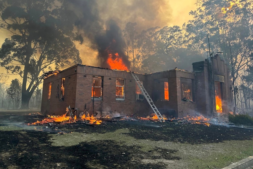 a brick home engulfed by fire