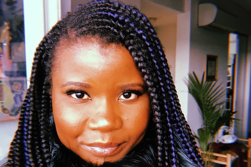 Smiling Santilla Chingaipe for story about her braided hair