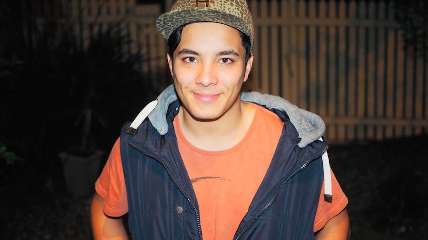 A young man in a shirt and a hat.