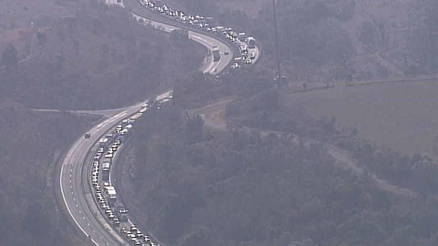 Aerial shot of a long snaking traffic jam on a regional highway