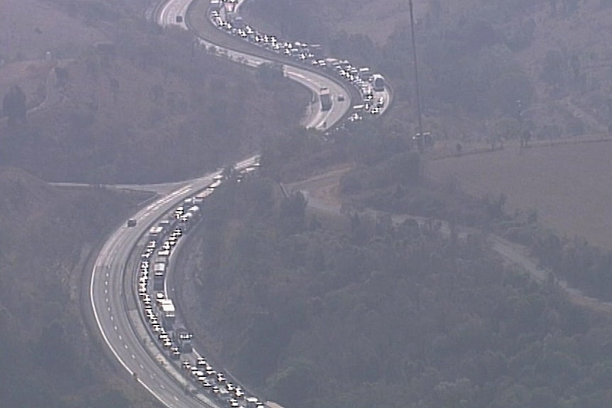 Aerial shot of a long snaking traffic jam on a regional highway