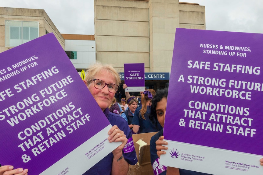 Nurses in South Australia holding placards at a march