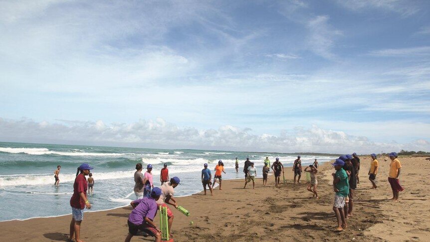 Locals play a game of beach cricket in Papua New Guinea.