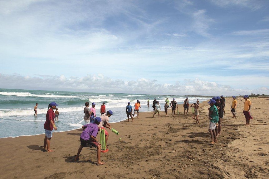 Locals play a game of beach cricket in Papua New Guinea.