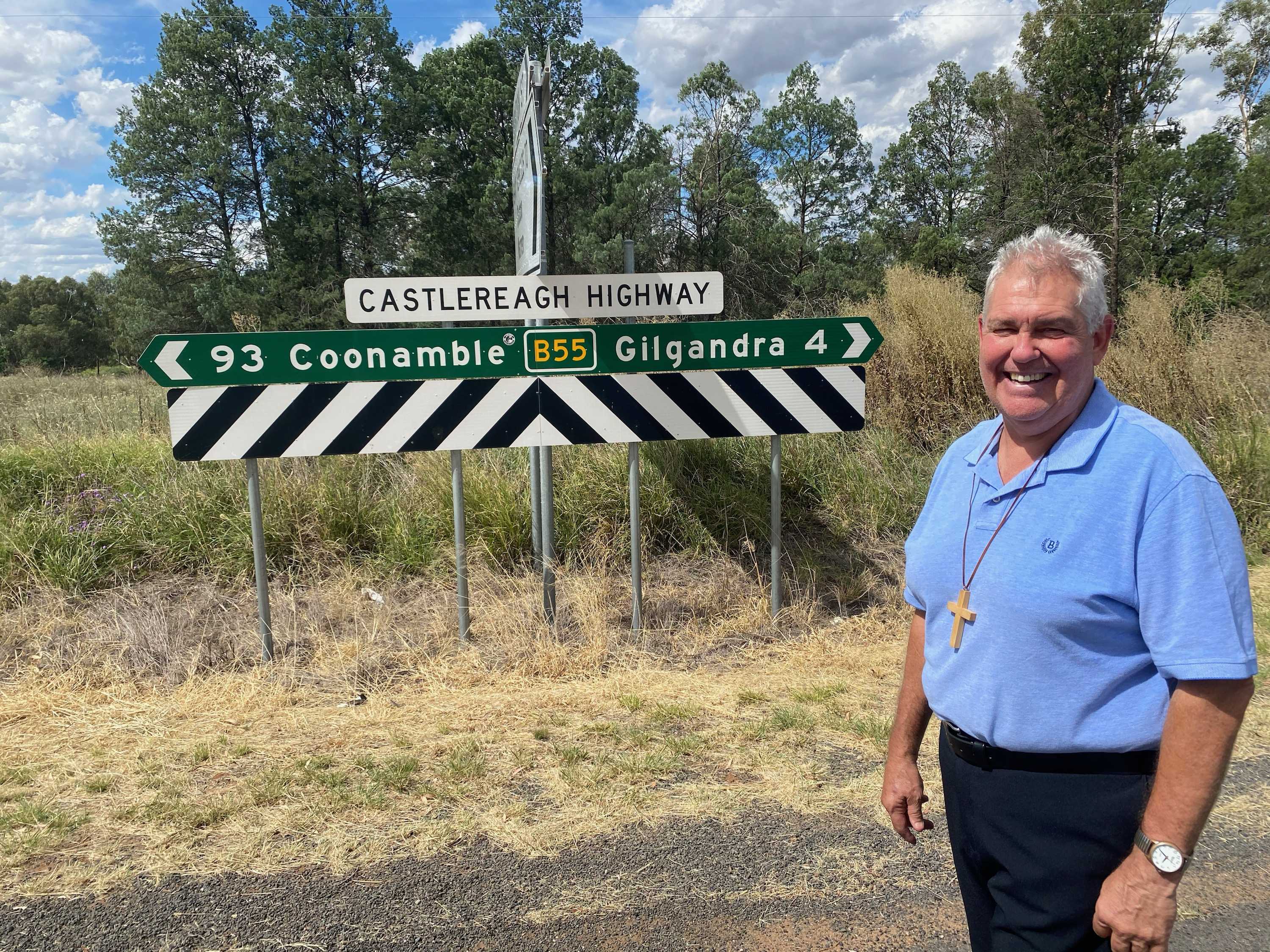Travelling minister Stuart Border stands in front of Castlereagh highway sign