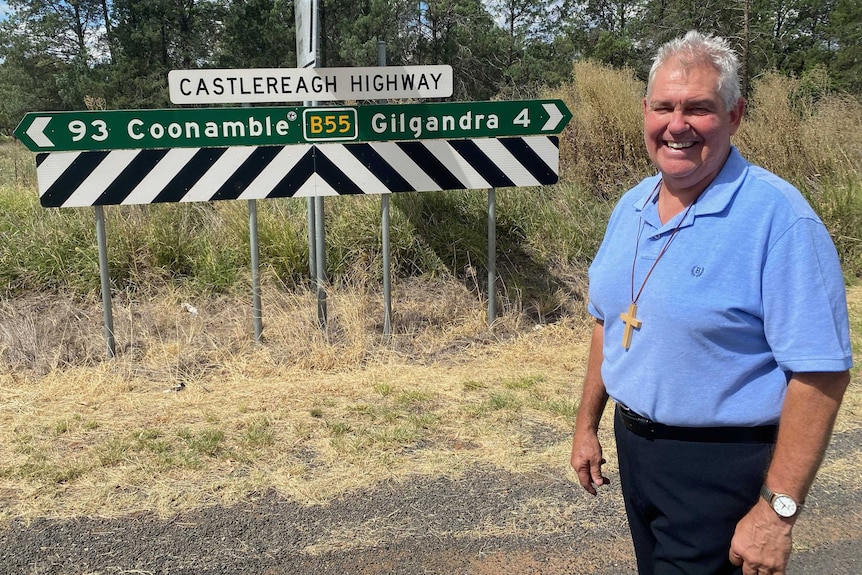 Travelling minister Stuart Border stands in front of Castlereagh highway sign