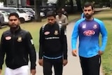 Several men in training gear walk quickly through a park in Christchurch.