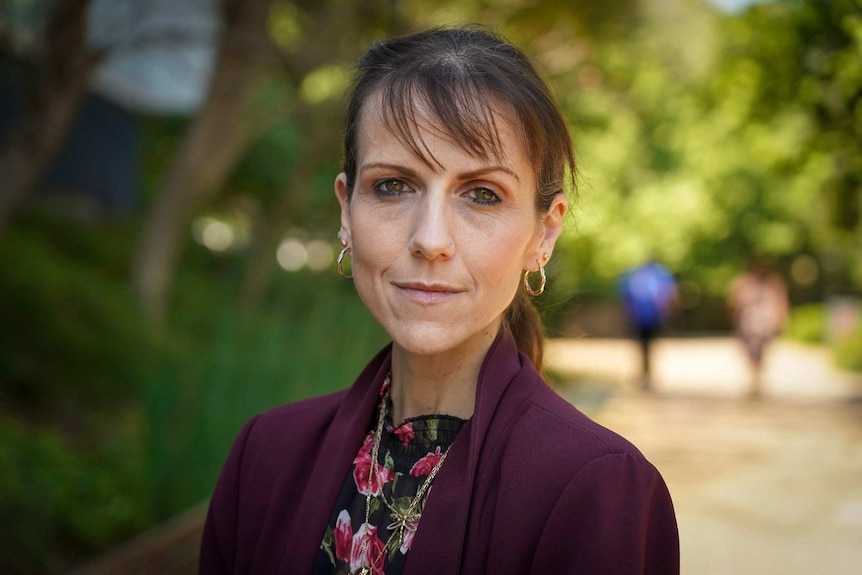 Headshot of a woman staring at the camera.