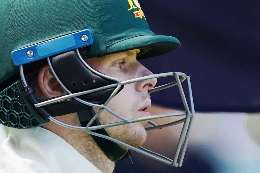 A close-up shot of Steve Smith breathing in with his helmet on.