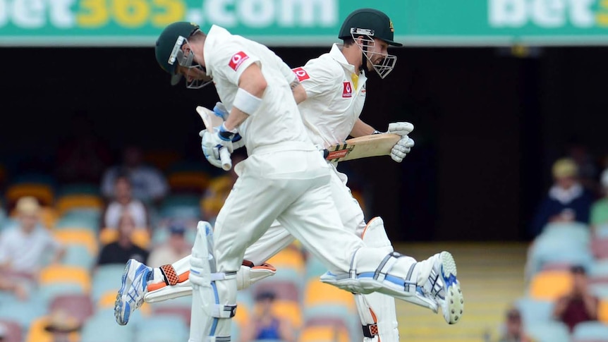 Michael Clarke (left) and Ed Cowan run between wickets