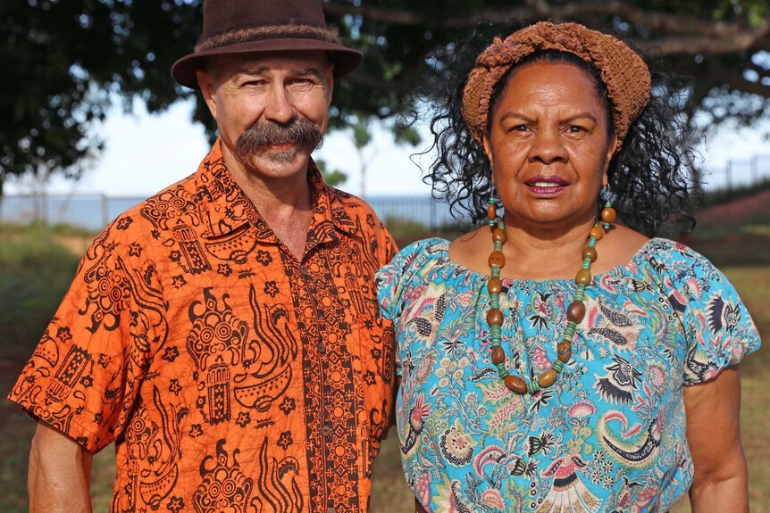 Dr Anne Poelina and Ian Perdristat stand outside, with green trees in the background.