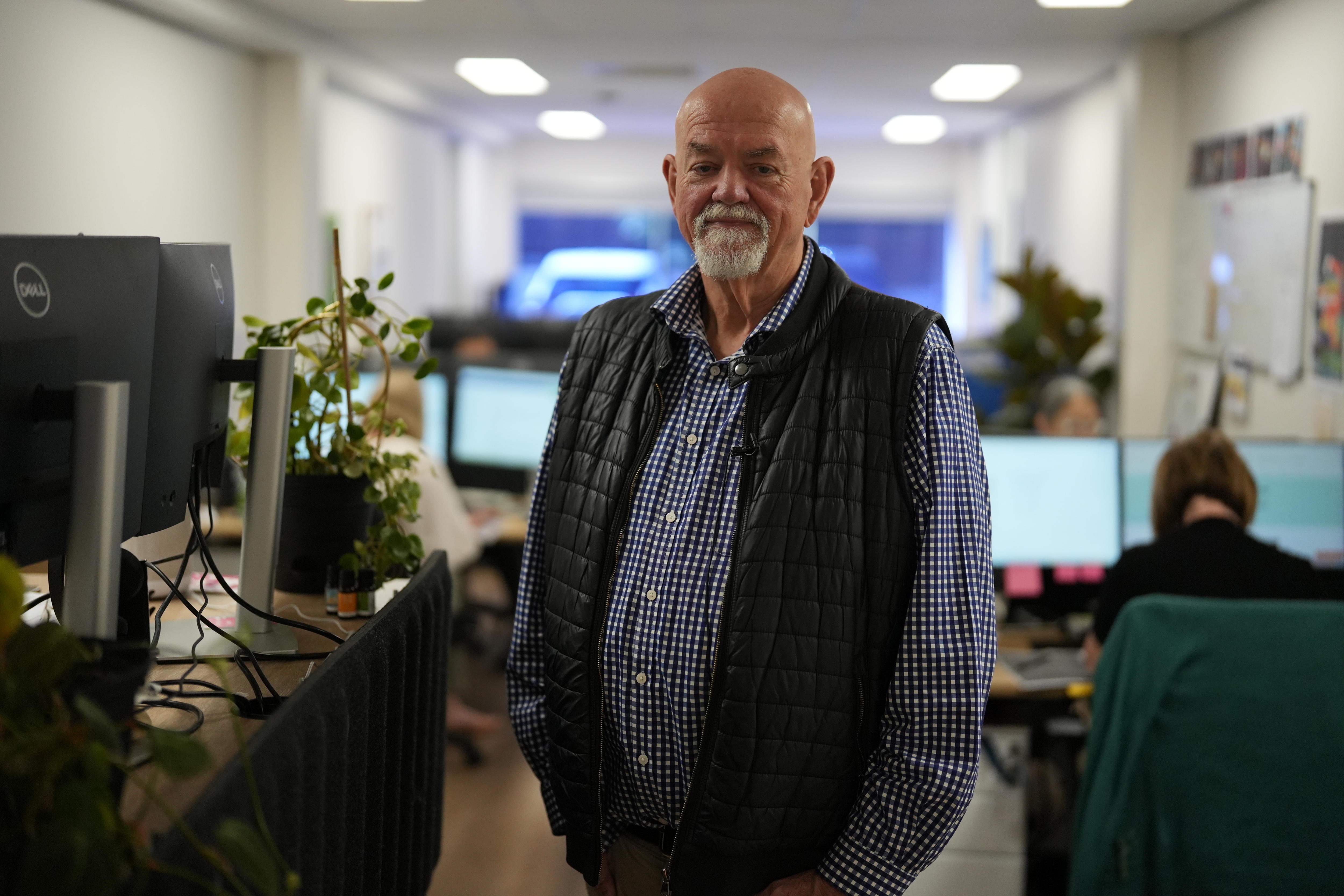 A man standing in an office 