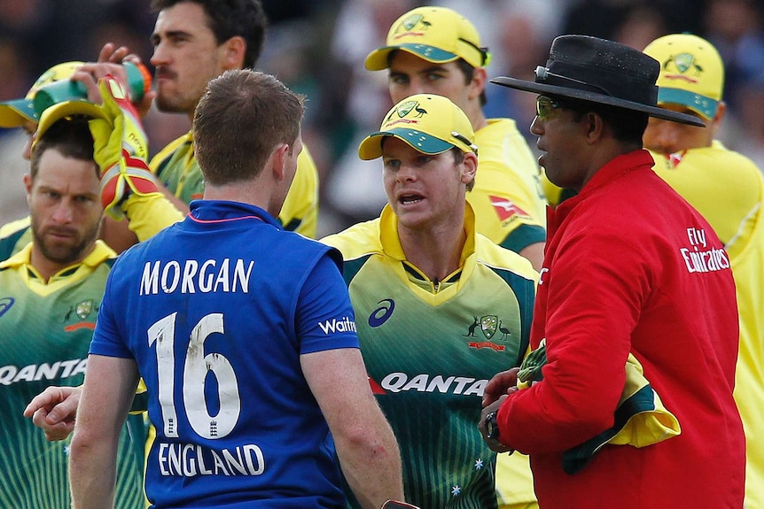 England’s captain Eoin Morgan (L) talks with Australia’s captain Steven Smith