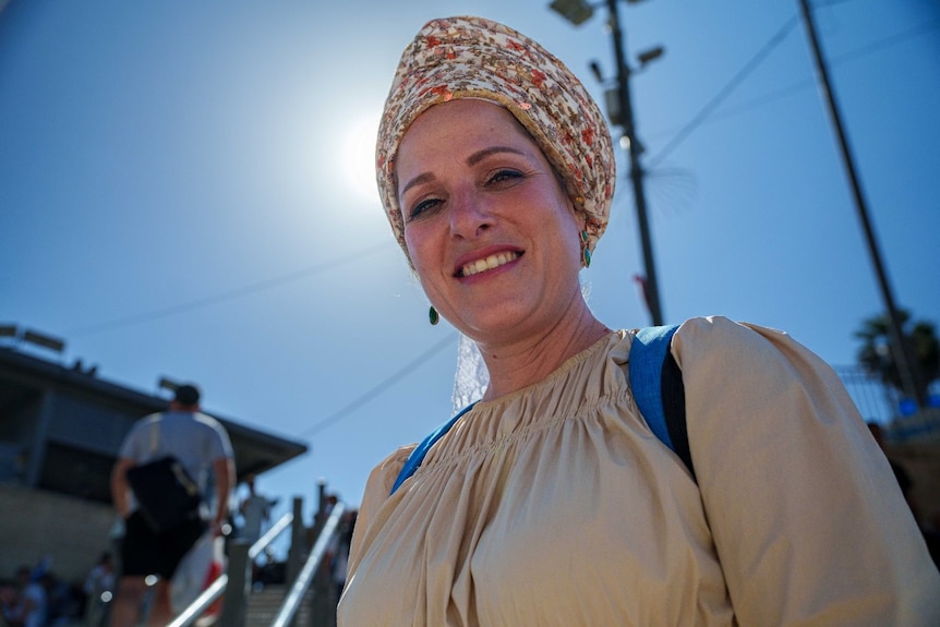 A woman smiles at the camera.