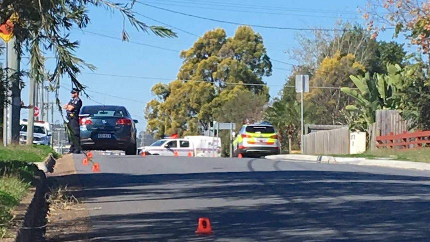 Evidence markers on the road at the scene of the Booval stabbing.