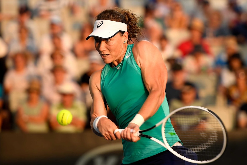 Samantha Stosur strains every muscle as she hits a backhand at the Brisbane International