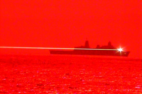 A bright light is seen fired from a Navy ship.