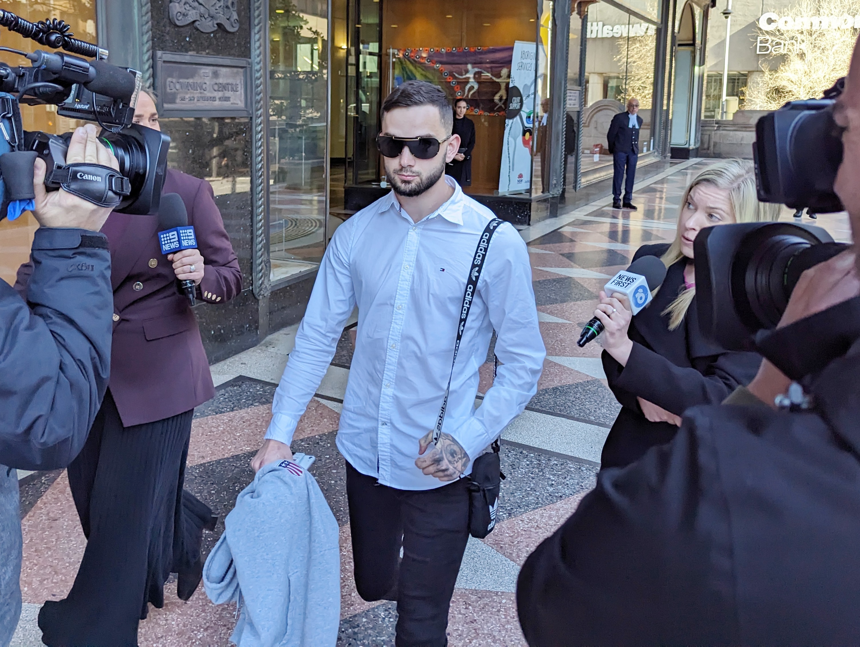 Christopher Walker arrives at court wearing sunglasses