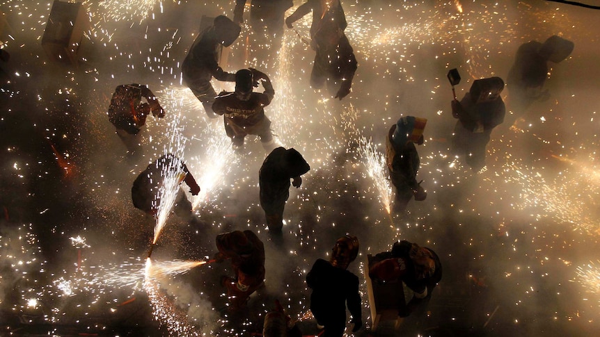 People let off fireworks during a village festival in Spain