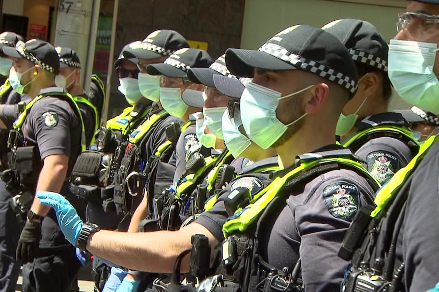 a line of uniformed police.